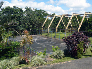 The lower court is between a volleyball court and a small soccer field, which is beneath the huge steel frame which used to hold the roof of a covered clay tenns court